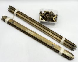 A collection of brass stair rods and brackets