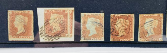 A collection of five Penny Red stamps