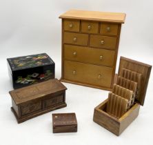 A jewellery box in the form of a miniature chest of drawers along with a small collection of