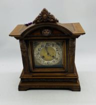 A Teutonia Glock Manufactory (German) mantle clock with carved detailing