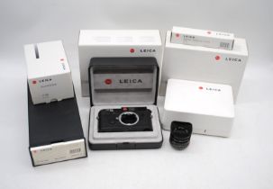 A boxed Leica M6 camera body in black, with a Leica Summicron-M 1:2/35 ASPH lens, a boxed Leica