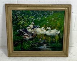 A framed oil on canvas painting of nesting ducks. Overall size 73cm x 63cm