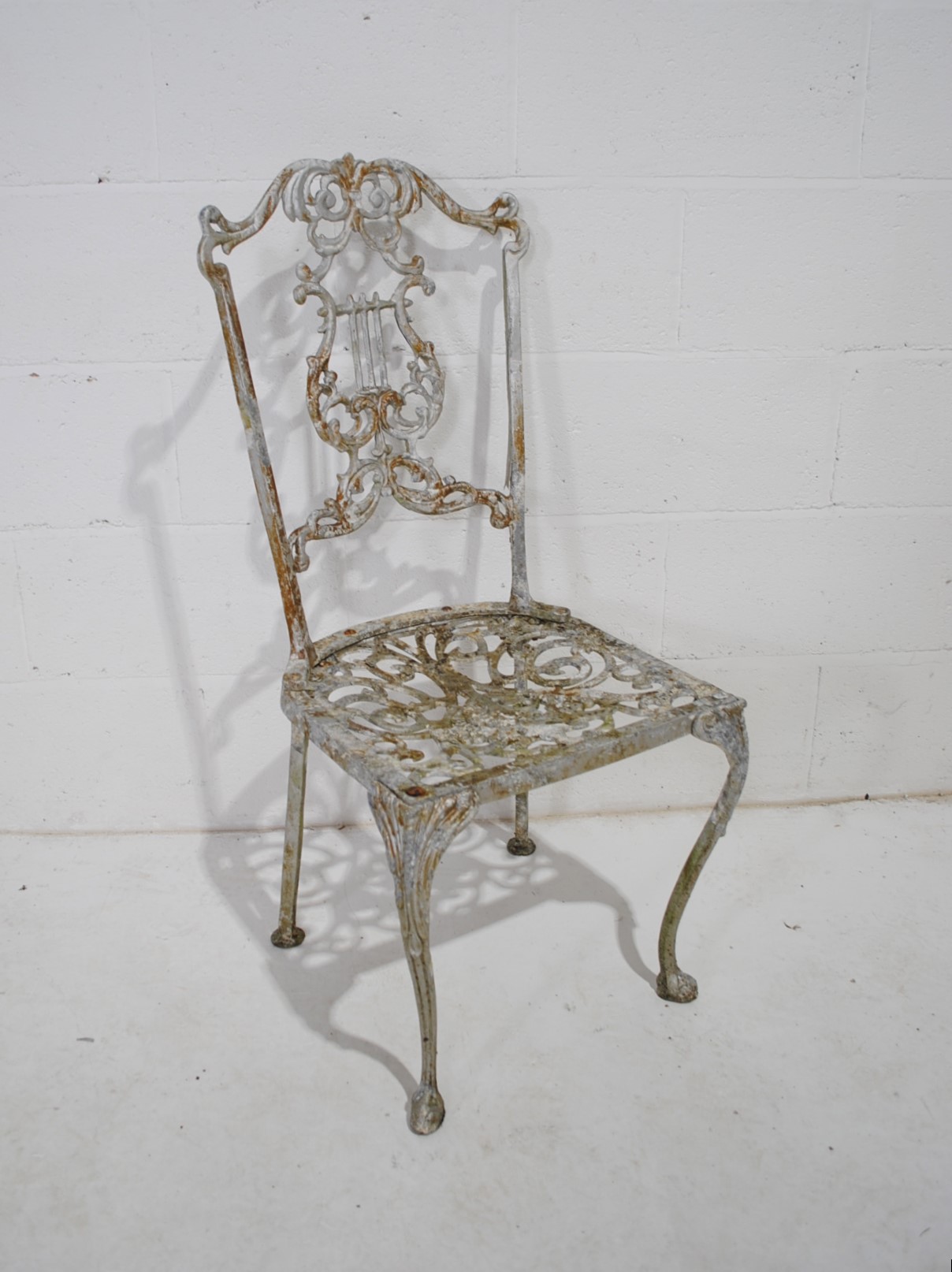 A weathered cast aluminium circular garden table with a set of eight chairs, with lyre backs - one - Image 12 of 12