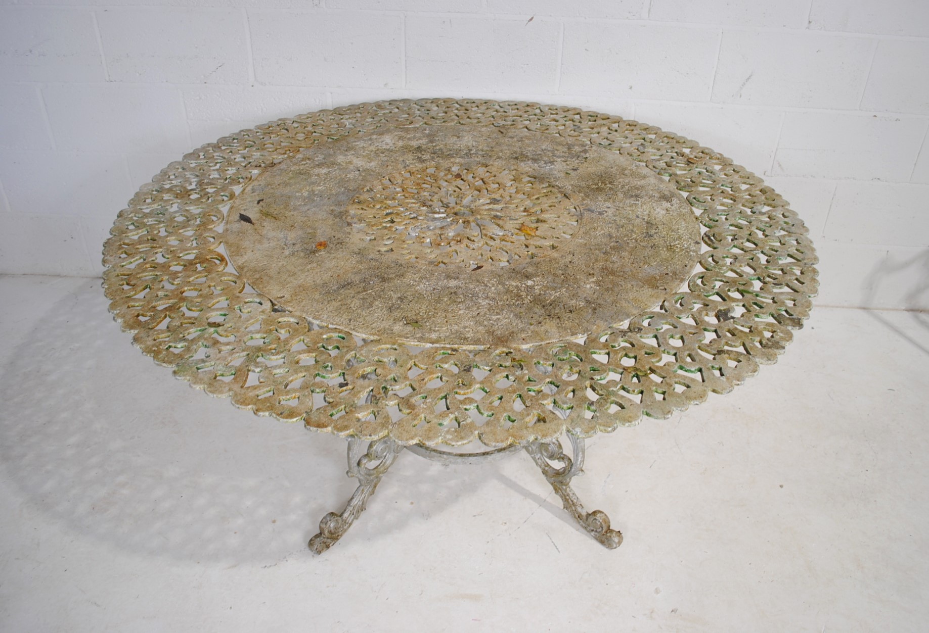 A weathered cast aluminium circular garden table with a set of eight chairs, with lyre backs - one - Image 6 of 12