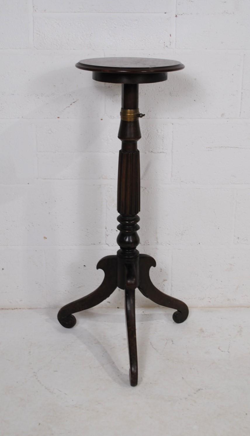 An antique mahogany adjustable plant stand