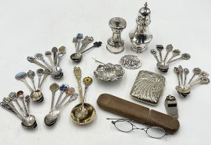 A collection of silver plated items including pepper grinder, sugar caster, spoons etc.