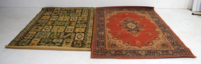 A green ground traditional Eastern style rug (216cm x 137cm), along with red ground traditional