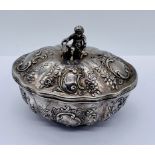 A continental silver oval pot and cover with import marks. The oval repousse pot with gilded
