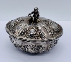 A continental silver oval pot and cover with import marks. The oval repousse pot with gilded