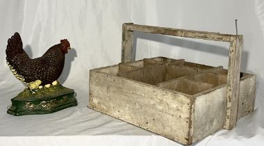 A cast iron doorstop in the form of a chicken along with a wooden trug