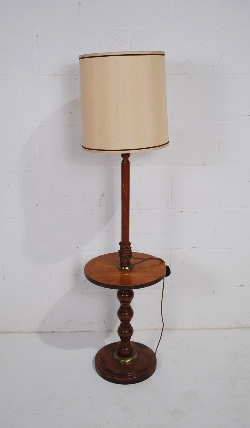A wooden standard lamp with table base
