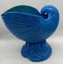 A large 19th century blue-glazed majolica jardinière modelled as a nautilus shell, impressed