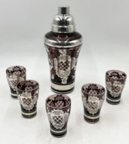 A glass Art Deco cocktail shaker and five matching glasses decorated with silvered bands and