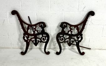 A pair of weathered cast iron bench ends
