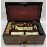 A Victorian burr walnut games compendium complete with chess set and board, draughts (only 14