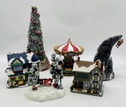 A collection of Christmas figures, scenes and groups including a fairground ride