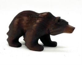 A wooden bear in a black forest style, height 13cm length 24cm