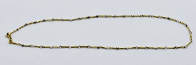 A 9ct gold necklace interspersed with white metal beads, weight 7.5g