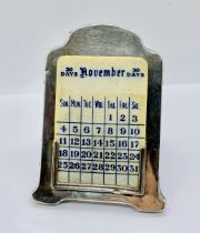 A hallmarked silver desk calendar