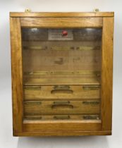 A vintage wall hanging fuse box with three internal drawers