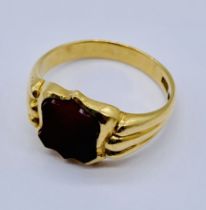 A gentleman's 18ct gold signet ring set with a shield shaped cornelian, total weight 8.2g, size W