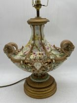 An impressive Royal Worcester lamp with hand painted floral decoration, twin rams head handles and