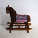 A vintage rocking horse on wooden frame