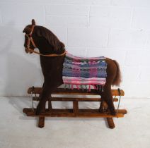 A vintage rocking horse on wooden frame