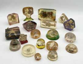 A collection of vintage Lucite paperweights and pen holders encasing various arrangements of sea