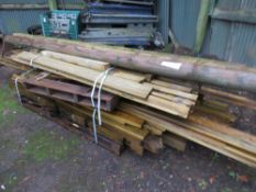 STACK OF ASSORTED FENCE POSTS AND TIMBERS, PRESSURE TREATED.