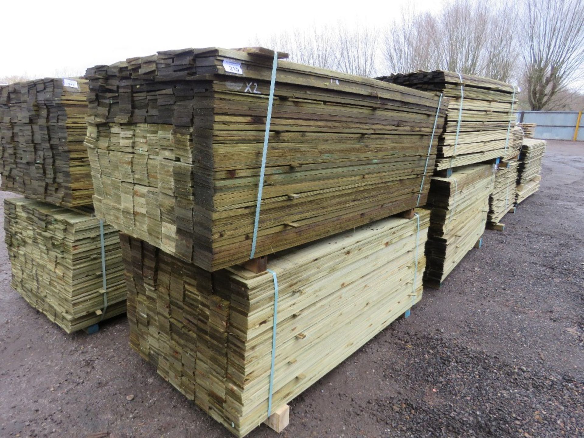 2 X LARGE PACKS OF TREATED FEATHER EDGE TIMBER CLADDING BOARDS: 1.80M LENGTH X 100MM WIDTH APPROX.