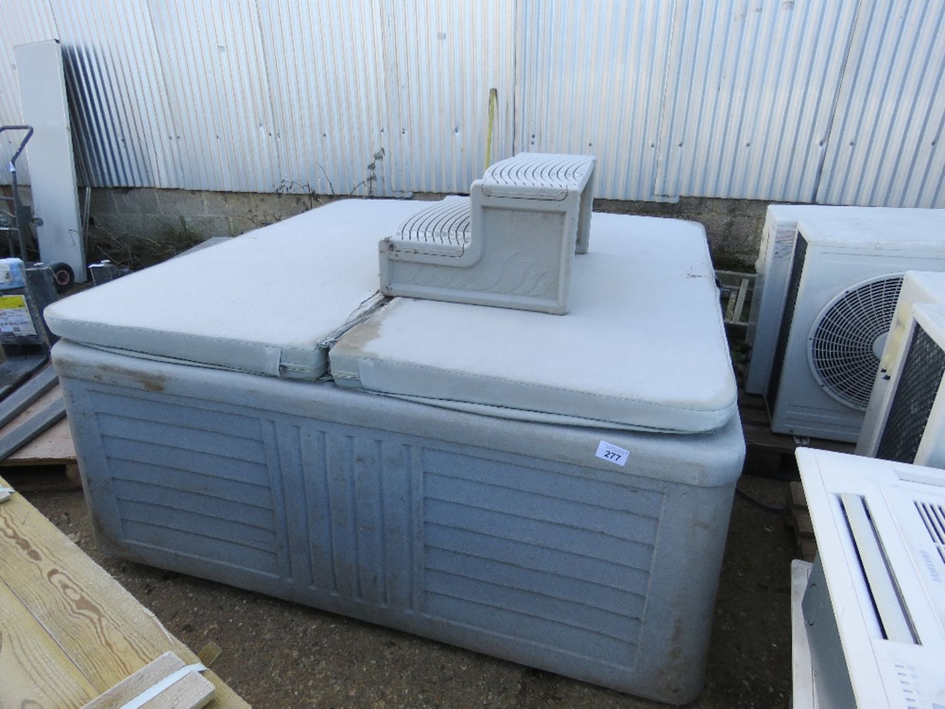 HARD SHELL HOT TUB JACUZZI UNIT WITH COVER AND STEPS. 6FT SQUARE APPROX. THIS LOT IS SOLD UNDER T