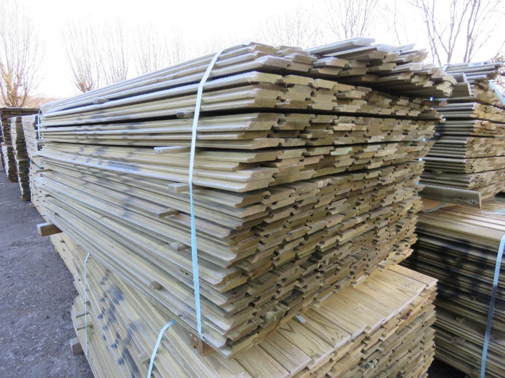 LARGE PACK OF PRESSURE TREATED SHIPLAP FENCE CLADDING BOARDS. 1.73M LENGTH X 100MM WIDTH APPROX.