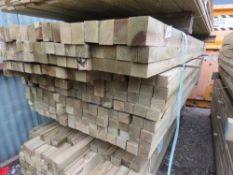 LARGE BUNDLE OF TREATED TIMBER POSTS, MAINLY 2.4 -2.7M LENGTH X 55MM X 45MM APPROX: 165NO IN TOTAL A