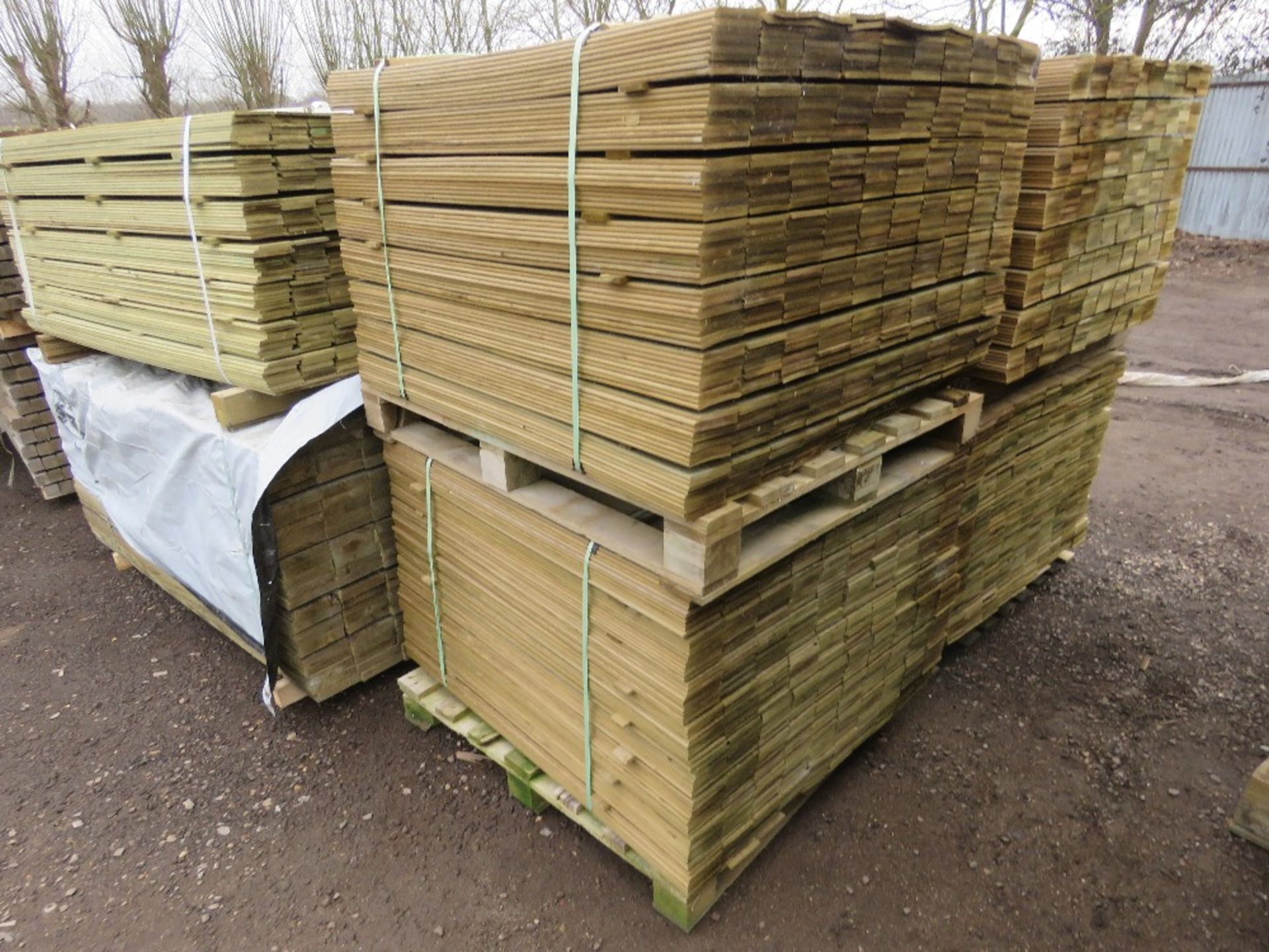 2 X PALLETS OF TREATED HIT AND MISS FENCE CLADDING BOARDS 1.04M LENGTH X 100MM WIDTH APPROX.