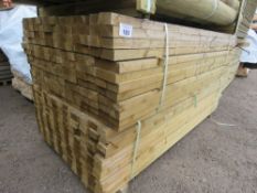 LARGE PACK OF TREATED TIMBER POSTS@1.83M LENGTH WITH A CHAMFERED EDGE, 70MM MAX WIDTH X 35MM APPROX.