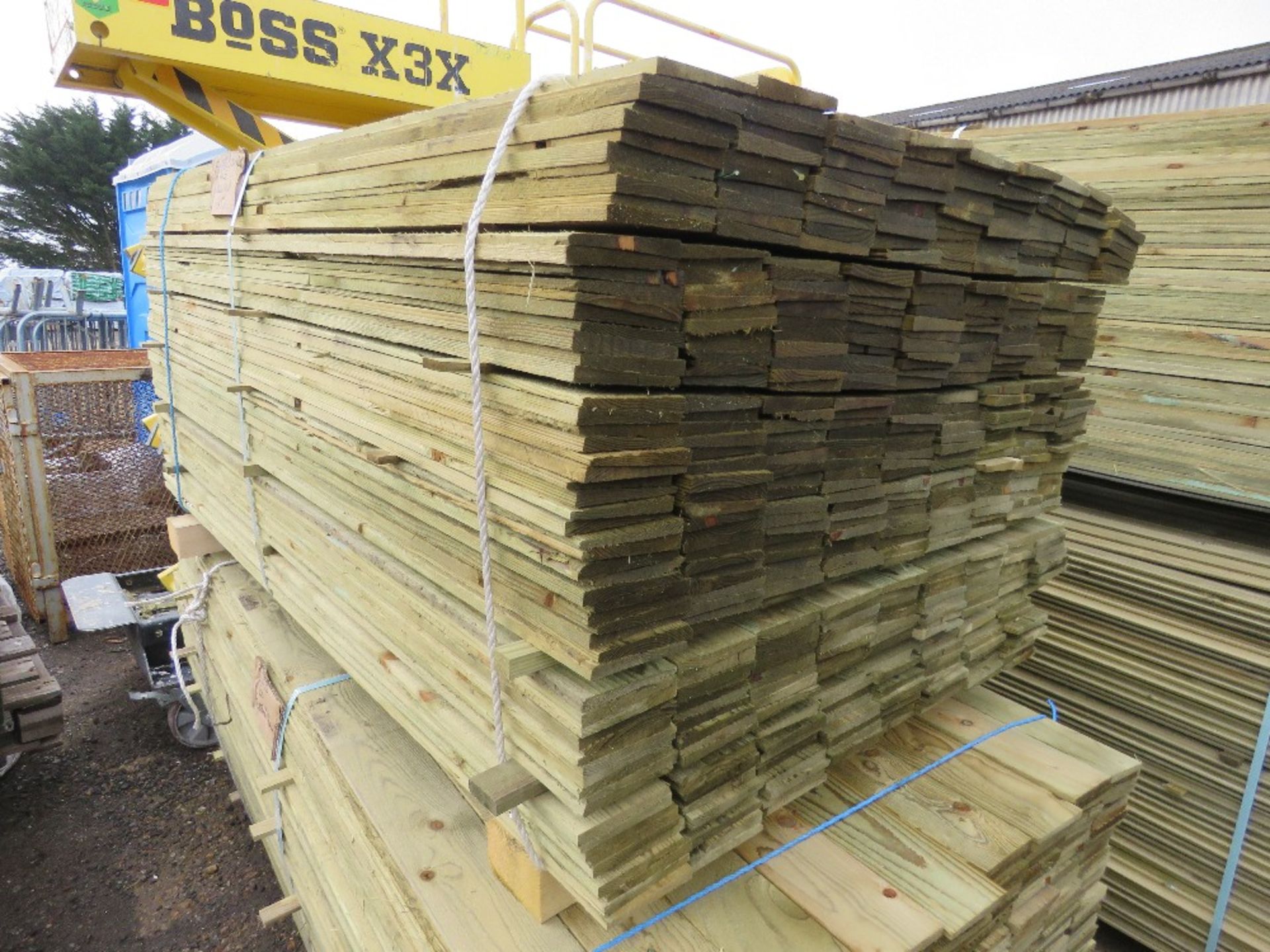 LARGE PACK OF TREATED FEATHER EDGE CLADDING BOARDS, MAJORITY ARE 1.6M LENGTH X 100MM WIDTH APPROX.