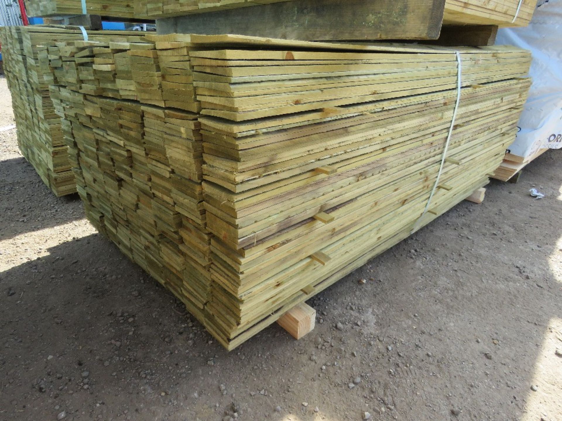 LARGE PACK OF TREATED FEATHER EDGE FENCE CLADDING BOARDS: 1.8M LENGTH X 100MM WIDTH APPROX.
