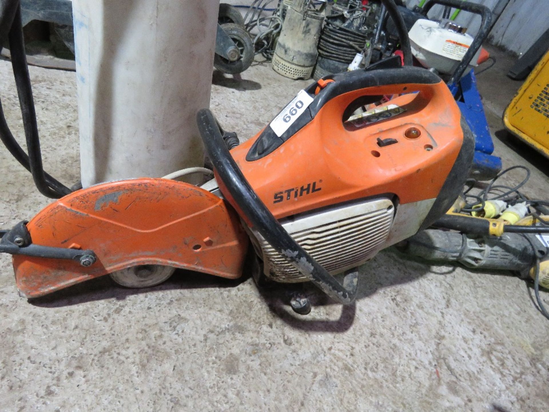 STIHL TS410 TYPE PETROL CUT OFF SAW PLUS A WET CUT BOTTLE. THIS LOT IS SOLD UNDER THE AUCTIONEERS
