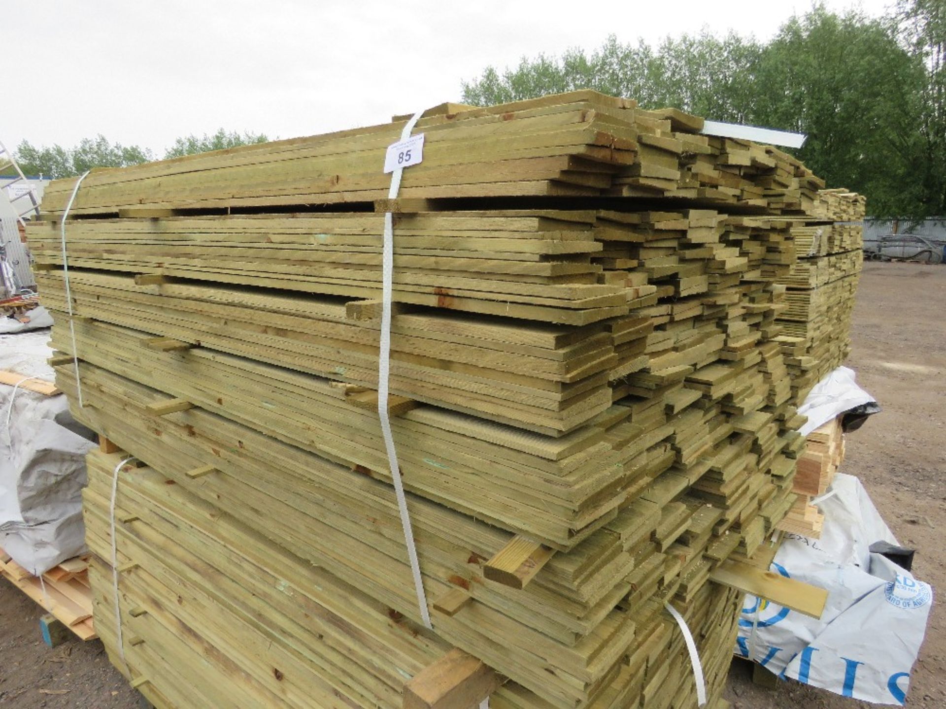 LARGE PACK OF TREATED FEATHER EDGE TIMBER CLADDING BOARDS. 1.8M LENGTH X 100MM WIDTH APPROX.
