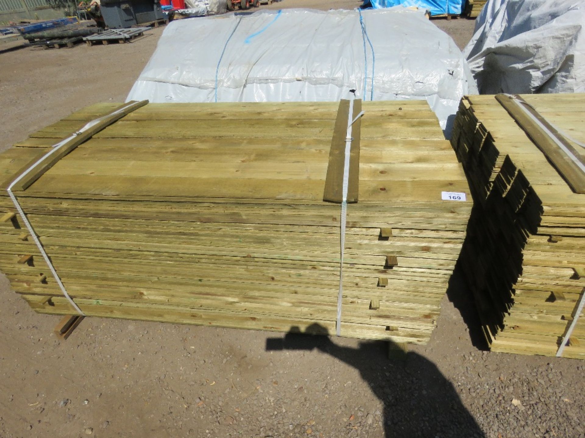 LARGE PACK OF TREATED FEATHER EDGE TIMBER CLADDING BOARDS: 1.8M LENGTH X 100MM WIDTH APPROX.