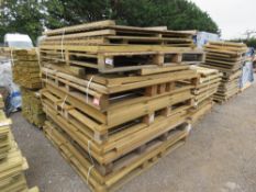 LARGE STACK OF ASSORTED FENCING PANELS.