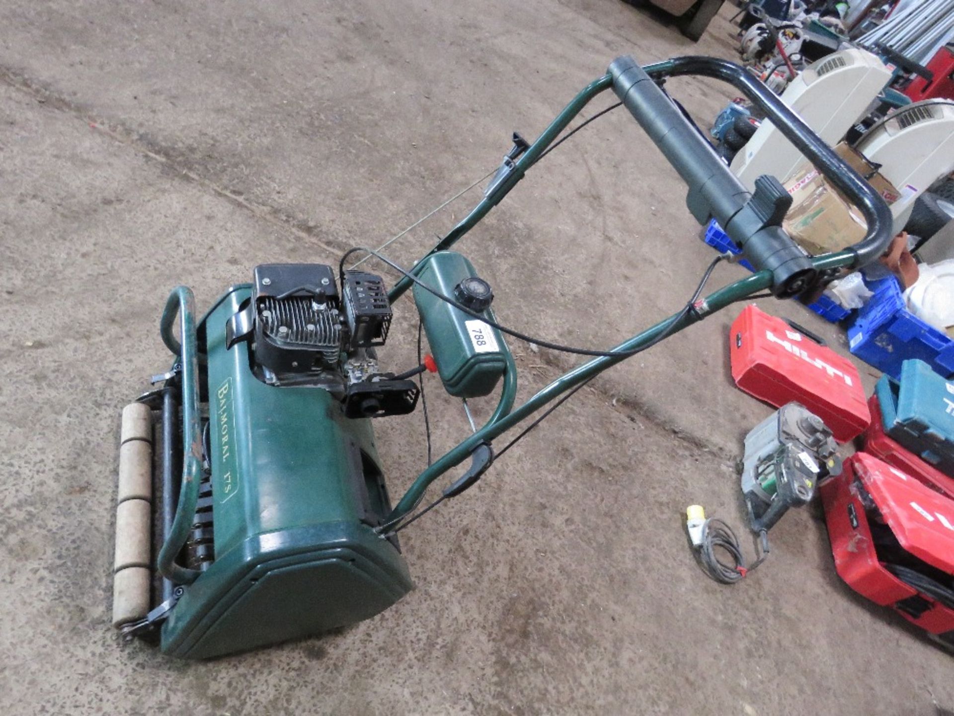 CYLINDER MOWER WITH RAKING / DE-THATCHING ATTACHMENT.
