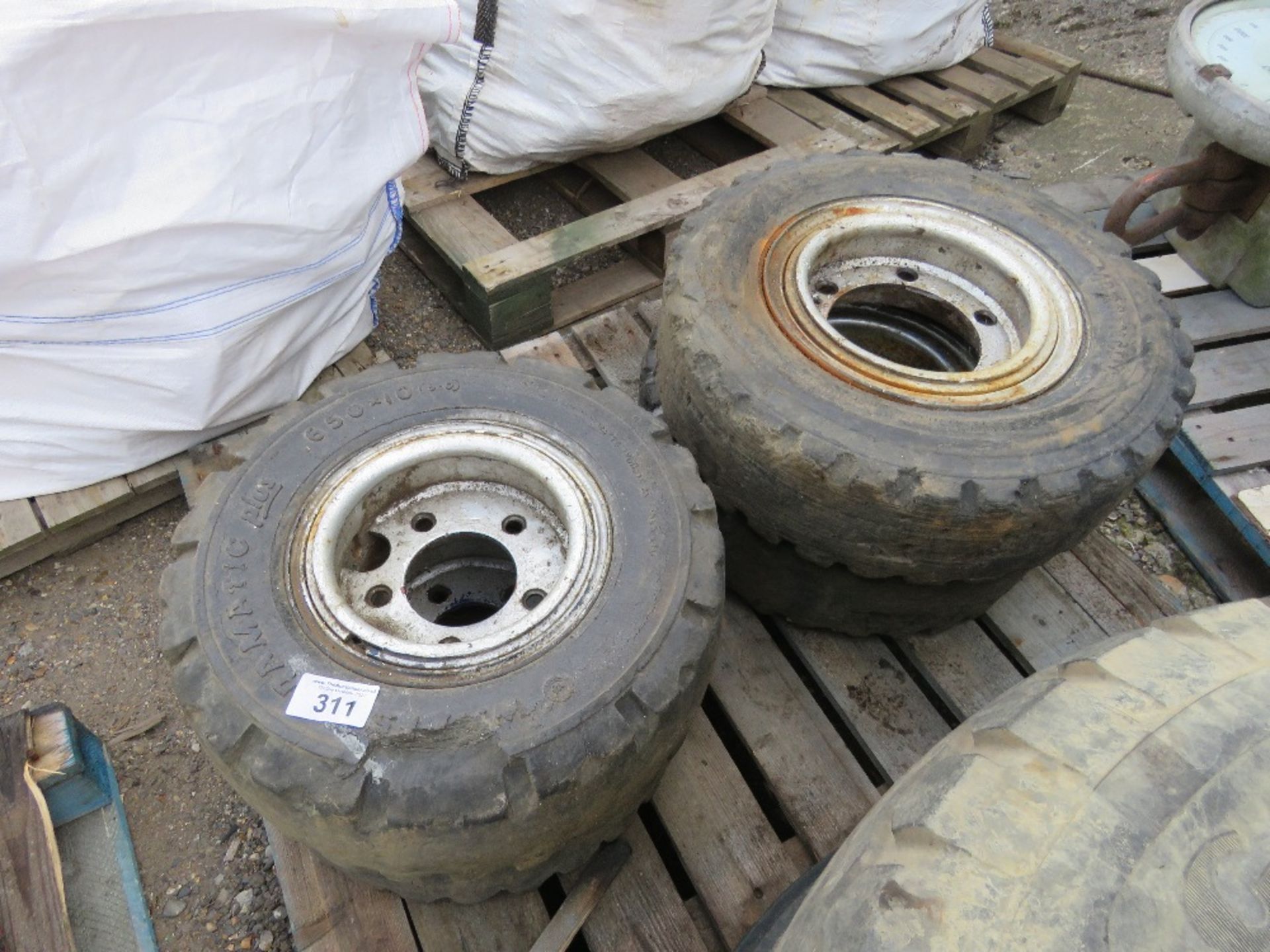 4 X SOLID FORKLIFT WHEELS AND TYRES 7.00X12 AND 6.50 X 10. THIS LOT IS SOLD UNDER THE AUCTIONEER