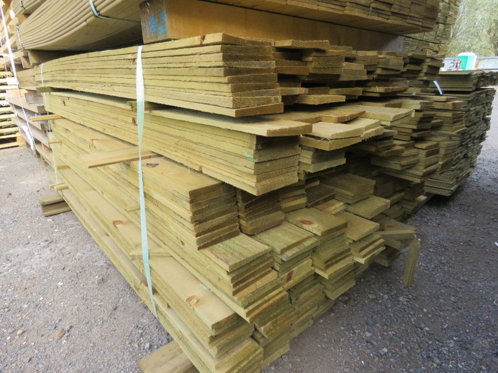 LARGE PACK OF TREATED FEATHER EDGE TIMBER CLADDING BOARDS: 1.4-1.8M LENGTH X 100MM WIDTH APPROX.