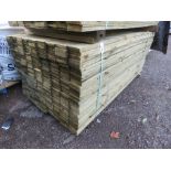 LARGE PACK OF TREATED FEATHEREDGE TIMBER CLADDING BOARDS. 1.8M LENGTH X 100MM WIDTH APPROX.