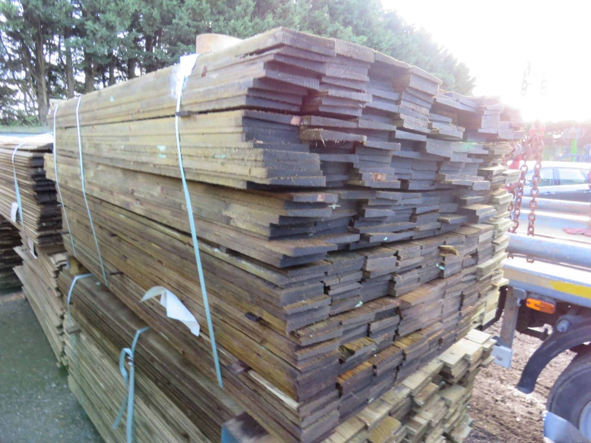 LARGE PACK OF FEATHEREDGE TREATED TIMBER CLADDING BOARDS. 1.8M LENGTH X 100MM WIDTH APPROX