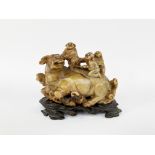 Asia, 20th centuryStrong sculpture of a calf and three laughing characters.On a carved woode