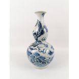 China, 19th centuryDouble gourd vase in enameled porcelain, with blue and white decor of a drago