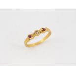 Gold metal ring decorated with two red stones and a white stone.Fingers: 57.